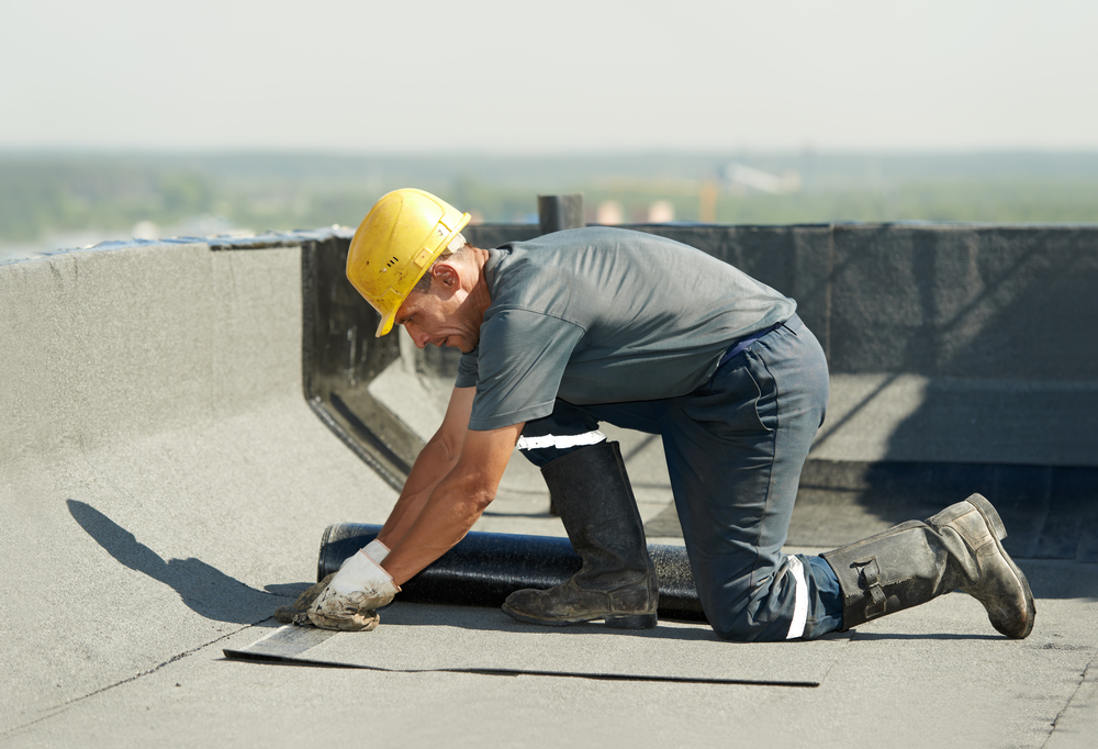 Roofer repairing roof